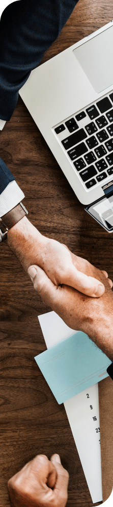 A close-up of two businessmen shaking hands.